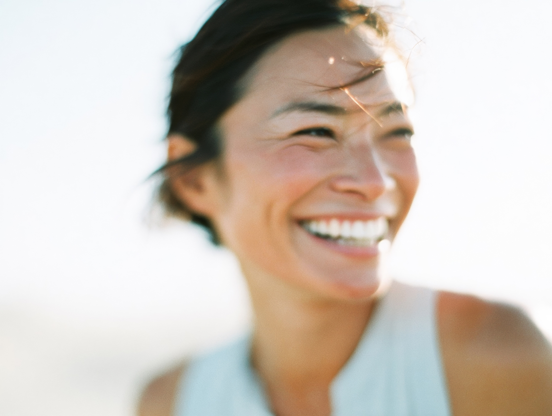 A woman in a white shirt, quietly radiant